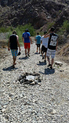 Our group walking past a fire pit as we made a short uphill hike.